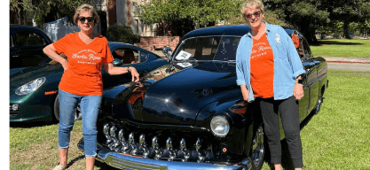 What We Do: Annual Campaign - alumni posing in front of a classic car.